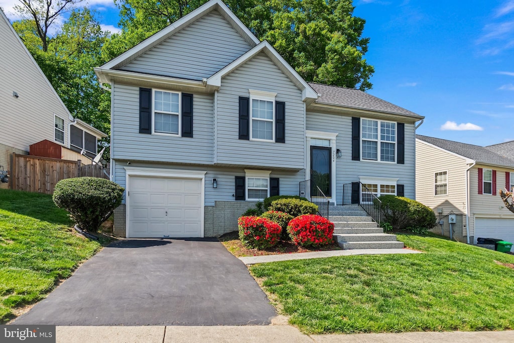 7204 Chapparal Dr, District Heights, MD 20747 - bi-level home featuring fence, an attached garage, driveway, and a front lawn