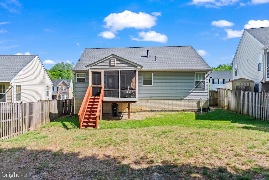 7204 Chapparal Dr, District Heights, MD 20747 - back of house featuring a lawn, a fenced backyard, stairs, and a sunroom