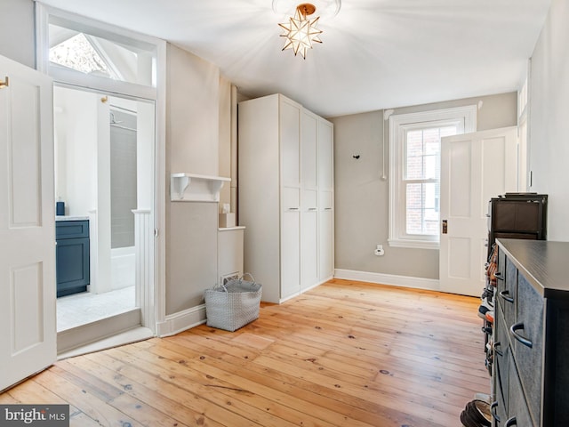 entrance foyer featuring baseboards and light wood-style flooring