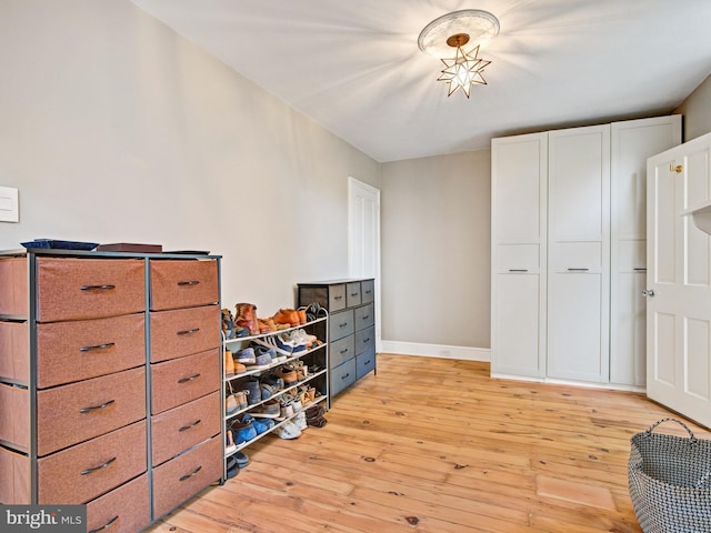 living area with baseboards and light wood finished floors