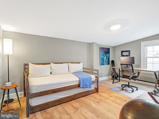 bedroom featuring baseboards and wood finished floors