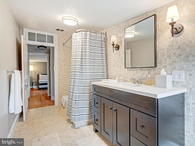 bathroom featuring visible vents, curtained shower, tile walls, and vanity