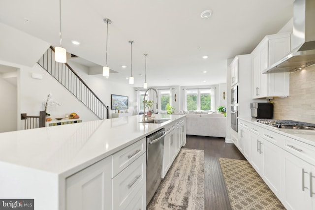 1702 River Sandstone Ter SE, Leesburg, VA 20175 - kitchen with wall chimney exhaust hood, a sink, stainless steel appliances, open floor plan, and dark wood finished floors
