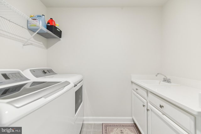 1702 River Sandstone Ter SE, Leesburg, VA 20175 - clothes washing area featuring washer and dryer, baseboards, light tile patterned flooring, and cabinet space