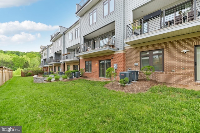 1702 River Sandstone Ter SE, Leesburg, VA 20175 - back of property with a yard, brick siding, a balcony, and central AC