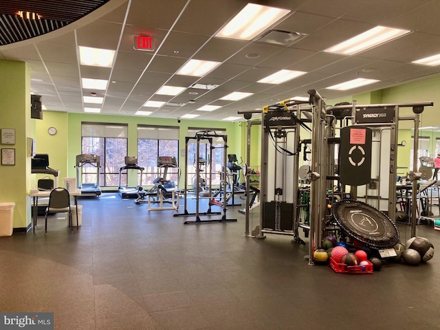 exercise room featuring visible vents and a paneled ceiling