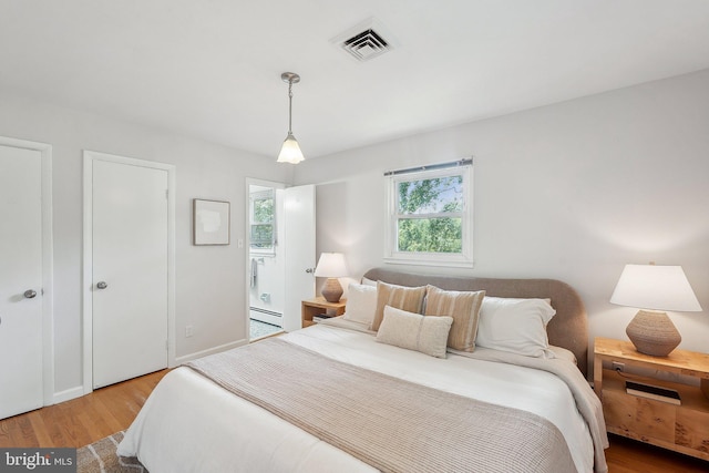 1612 7th Pl, Mclean, VA 22101 - bedroom with a baseboard heating unit and wood finished floors