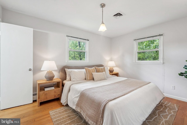 1612 7th Pl, Mclean, VA 22101 - bedroom featuring multiple windows, light wood-type flooring, and baseboards