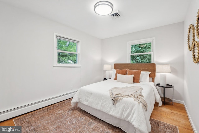 1612 7th Pl, Mclean, VA 22101 - bedroom featuring baseboard heating, light wood-style flooring, and baseboards