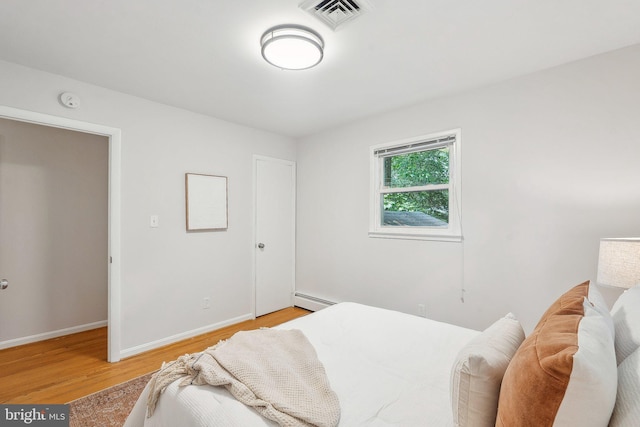 1612 7th Pl, Mclean, VA 22101 - bedroom featuring a baseboard heating unit, light wood-style floors, and baseboards