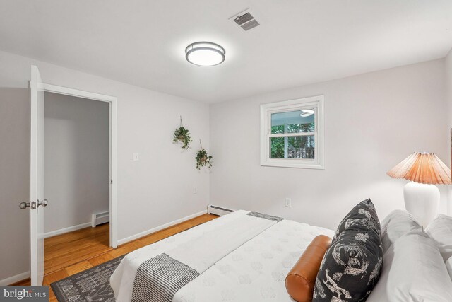 1612 7th Pl, Mclean, VA 22101 - bedroom featuring baseboard heating, light wood-style floors, and baseboards