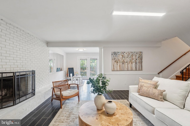 1612 7th Pl, Mclean, VA 22101 - living area with wood tiled floors, stairway, a brick fireplace, and brick wall