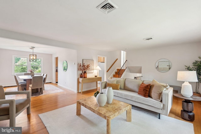 1612 7th Pl, Mclean, VA 22101 - living area with light wood-type flooring, baseboards, stairway, and a chandelier