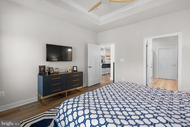 bedroom featuring baseboards and wood finished floors