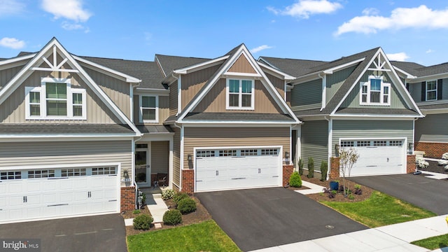 view of front of house featuring an attached garage, aphalt driveway, board and batten siding, and brick siding