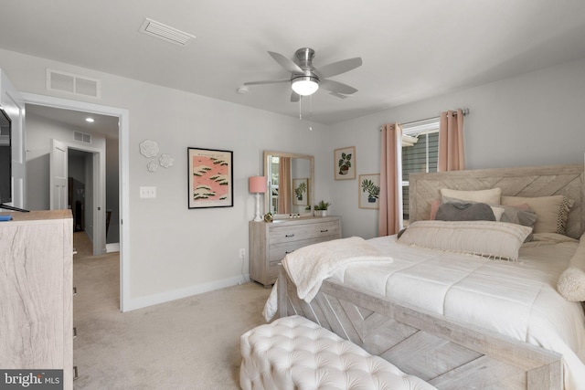 bedroom with baseboards, light colored carpet, and visible vents