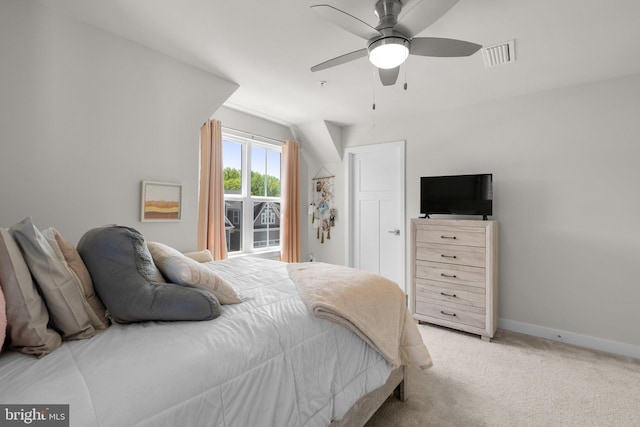 bedroom featuring baseboards, visible vents, light carpet, and ceiling fan