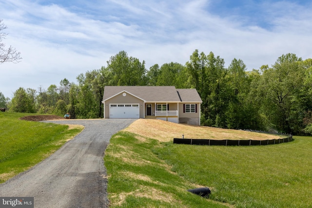 ranch-style home featuring driveway, an attached garage, and a front lawn