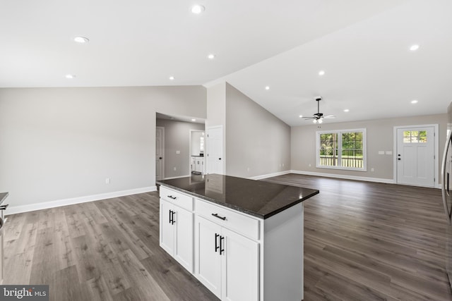 kitchen featuring a kitchen island, vaulted ceiling, ceiling fan, dark wood-style flooring, and open floor plan