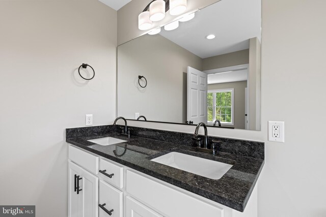 bathroom with double vanity and a sink