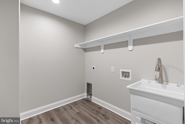laundry room with electric dryer hookup, dark wood-style floors, baseboards, hookup for a washing machine, and laundry area