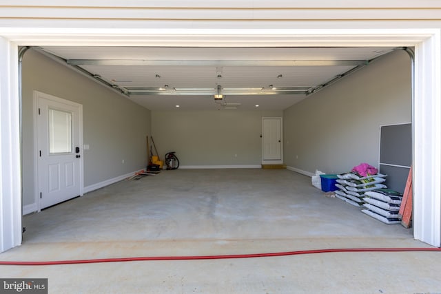 garage with baseboards and a garage door opener