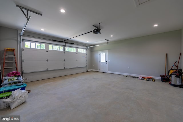 garage with a garage door opener, recessed lighting, and baseboards