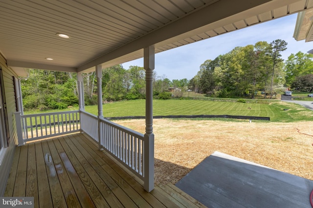 deck with covered porch and a lawn
