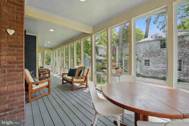 sunroom with a wealth of natural light and beam ceiling