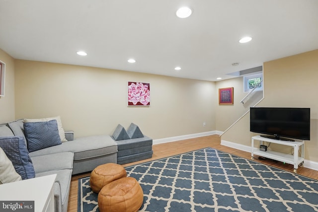 living room featuring recessed lighting, wood finished floors, and baseboards