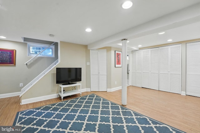 finished basement with baseboards, recessed lighting, and wood finished floors