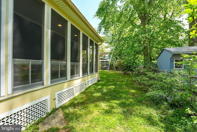 view of yard with fence and a sunroom