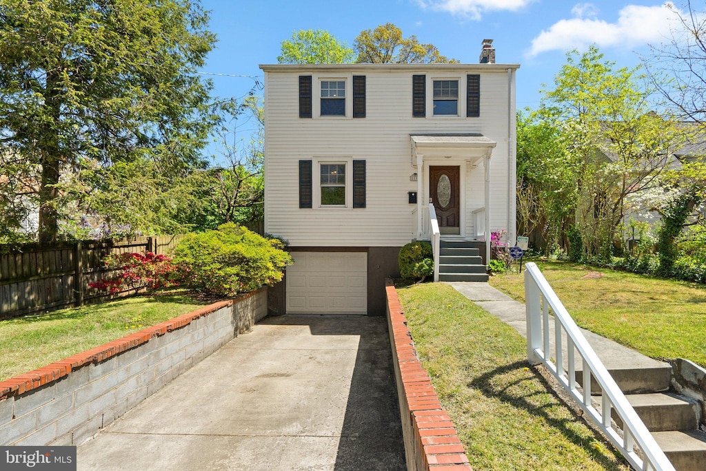 5803 41st Ave, Hyattsville, MD 20781 - view of front facade with driveway, a chimney, and an attached garage