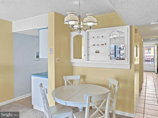 13400 Coastal Hwy Unit N405, Ocean City, MD 21842 - dining room featuring an inviting chandelier, a textured ceiling, and baseboards