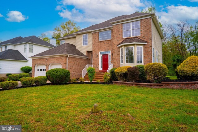 24 Chesapeake Rd, Monmouth Junction, NJ 08852 - traditional home featuring a garage, brick siding, and a front yard