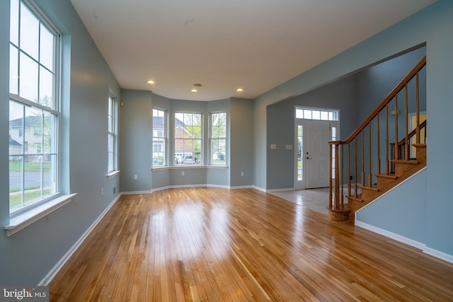 24 Chesapeake Rd, Monmouth Junction, NJ 08852 - entrance foyer with wood-type flooring, stairs, a wealth of natural light, and baseboards