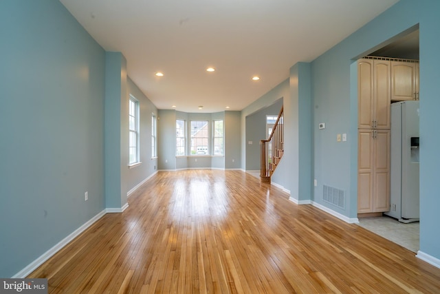 24 Chesapeake Rd, Monmouth Junction, NJ 08852 - unfurnished living room featuring stairway, visible vents, light wood-style floors, baseboards, and recessed lighting