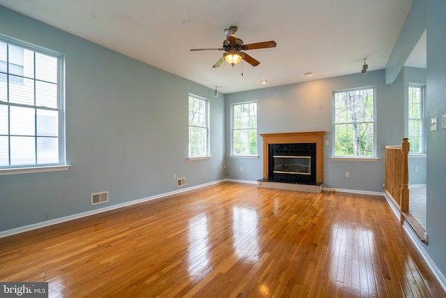 24 Chesapeake Rd, Monmouth Junction, NJ 08852 - unfurnished living room featuring visible vents, ceiling fan, hardwood / wood-style floors, and baseboards