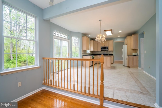 24 Chesapeake Rd, Monmouth Junction, NJ 08852 - kitchen with an inviting chandelier, stainless steel microwave, light brown cabinetry, freestanding refrigerator, and dishwasher