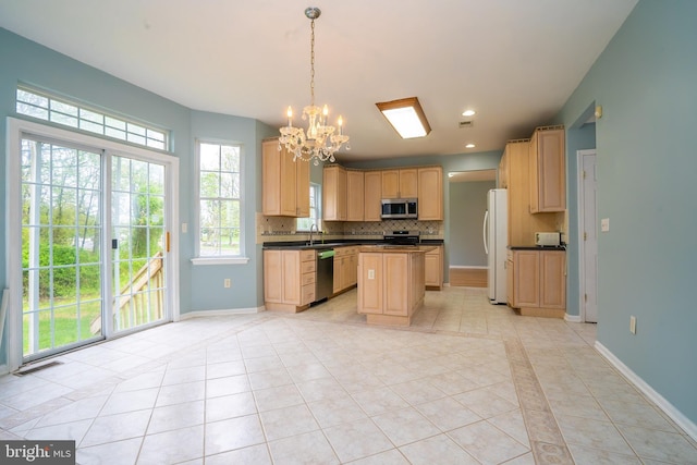 24 Chesapeake Rd, Monmouth Junction, NJ 08852 - kitchen featuring appliances with stainless steel finishes, light tile patterned floors, an inviting chandelier, and decorative backsplash