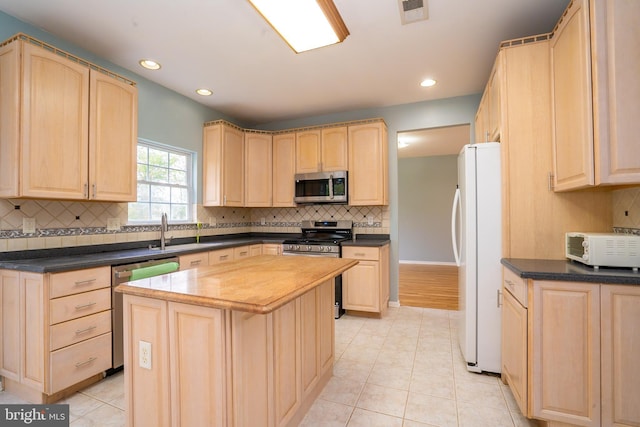 24 Chesapeake Rd, Monmouth Junction, NJ 08852 - kitchen with light brown cabinetry, visible vents, stainless steel appliances, and a sink