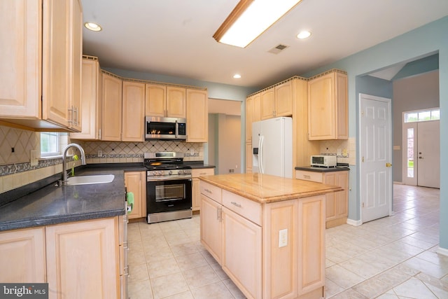 24 Chesapeake Rd, Monmouth Junction, NJ 08852 - kitchen with a sink, decorative backsplash, stainless steel appliances, light brown cabinets, and visible vents