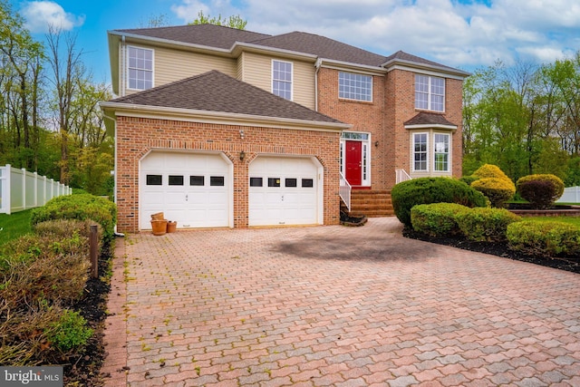 24 Chesapeake Rd, Monmouth Junction, NJ 08852 - traditional-style house featuring a garage, brick siding, fence, and decorative driveway