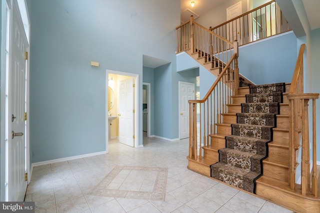 24 Chesapeake Rd, Monmouth Junction, NJ 08852 - tiled foyer entrance featuring stairway, baseboards, and a high ceiling