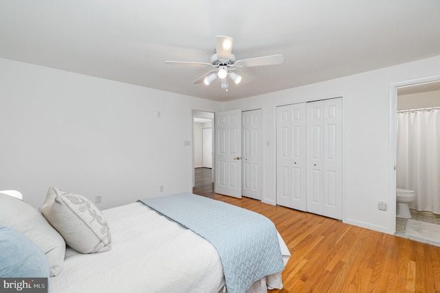 4 Hallbrook Ct, Baltimore, MD 21236 - bedroom featuring multiple closets, wood finished floors, baseboards, a ceiling fan, and ensuite bath