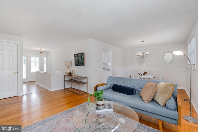 4 Hallbrook Ct, Baltimore, MD 21236 - living room with baseboards, a chandelier, visible vents, and light wood-type flooring