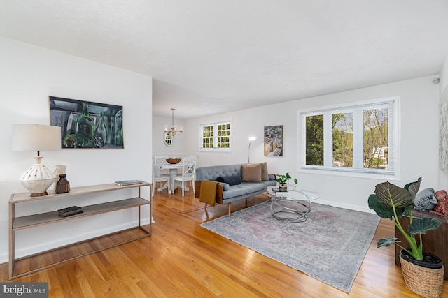 4 Hallbrook Ct, Baltimore, MD 21236 - living room featuring baseboards, light wood-style flooring, and a notable chandelier