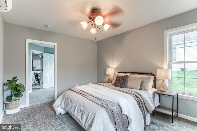 bedroom with multiple windows, baseboards, and carpet floors