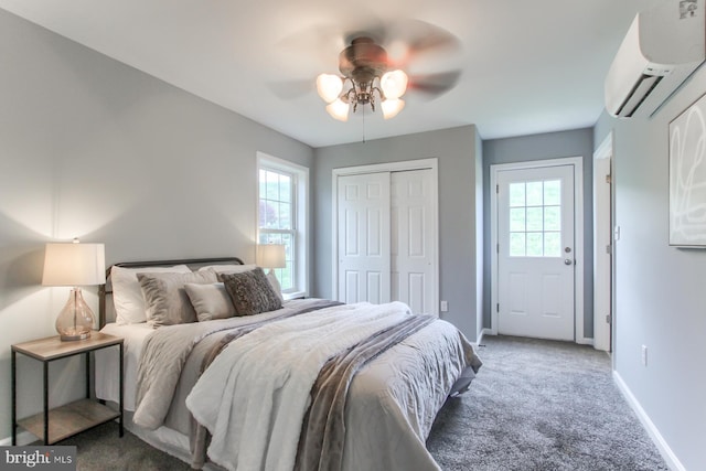 bedroom with baseboards, a wall mounted air conditioner, carpet floors, and multiple windows