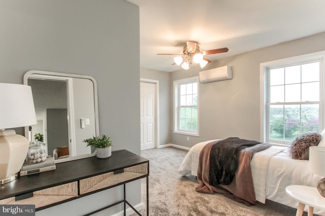 carpeted bedroom with baseboards, a wall unit AC, and a ceiling fan